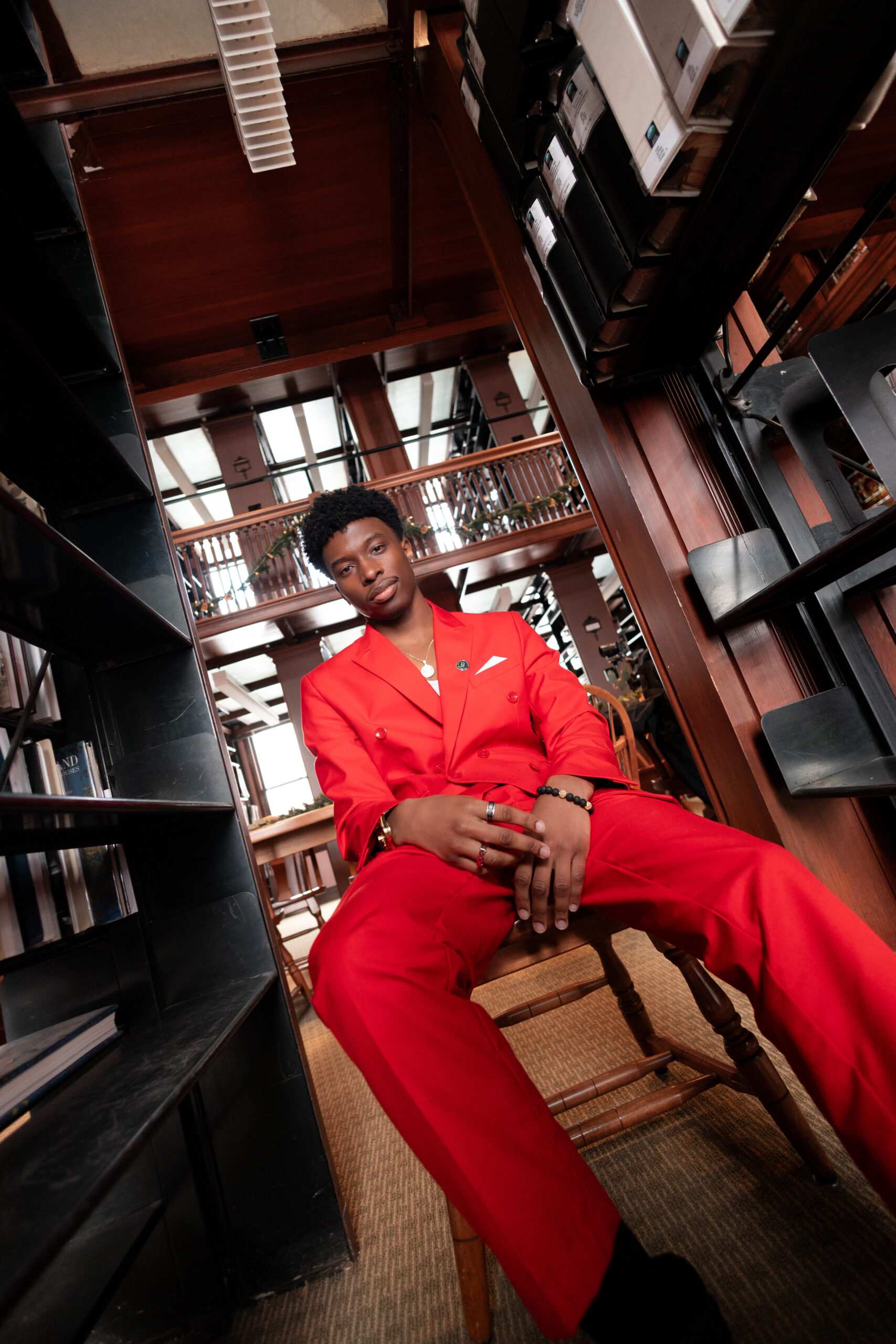 Man in a red suit in the library stacks